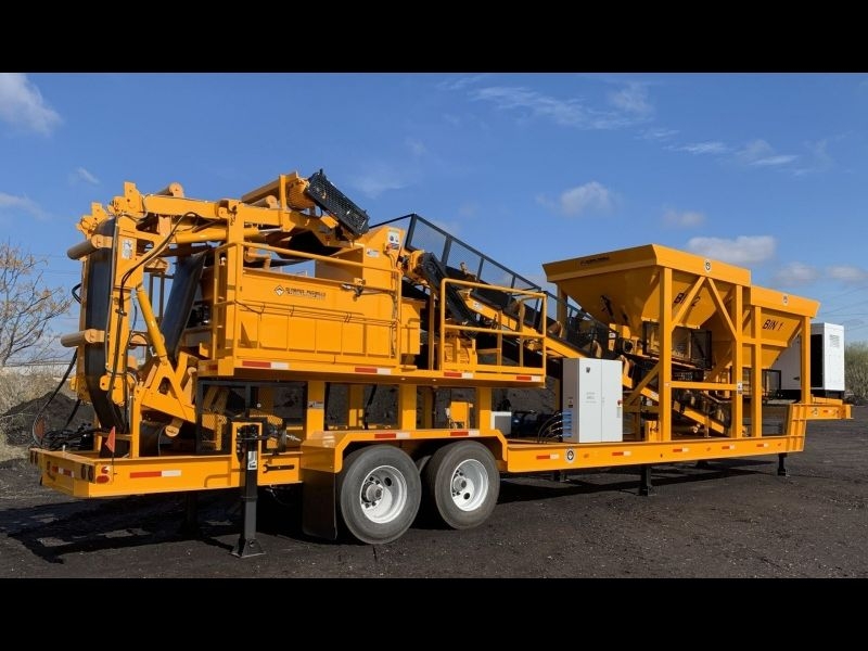 Olympus 2 bin pugmill system shown with conveyor discharge, onboard generator, vibrators and weigh pridge