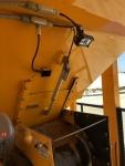 Close up of the Olympus cold feed bin hydraulically activated bin gate and LED lighting shown at the bin gate opening