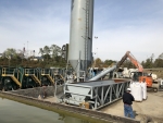 Pugmill System designed for sludge by PavementGroup.com shown with sludge bin, incline screw, pugmill and silo