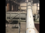 Incline screw tp 100tph pugmill, for liquid or sludge; part of SludgePUG pugmill system by pavementgroup.com designed for liquid waste solidification by PavementGroup.com shown with sludge bin, incline screw, pugmill and silo, easily transportable shown w