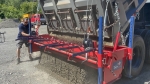 Chip Spreader, AmeriSpreader by PavementGroup shown with adjustable gate and mounting legs